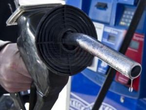 A man replaces the nozzle after filling up at a gas station Wednesday, February 23, 2011 in Montreal. The price of oil has been climbing as turmoil in Libya fuels fears that unrest could spread to other oil-producing nations and choke supplies. THE CANADIAN PRESS/Paul Chiasson