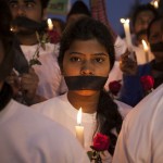 Indian women participate in a candle light vigil at a bus stop where the victim of a deadly gang rape in a moving bus had boarded the bus two years ago, in New Delhi, India, Tuesday, Dec. 16, 2014. The case sparked public outrage and helped make womens safety a common topic of conversation in a country where rape is often viewed as a womans personal shame to bear. (AP Photo/Tsering Topgyal)