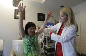 In this Sept. 26, 2015, photo, Dr. Jill Waibel examines Kim Phuc before the first of several laser treatments to reduce pain and the appearance of burn scars in her back and left arm in Miami. Phuc was injured by a napalm bomb in Vietnam 40 years ago. (AP Photo/Nick Ut)