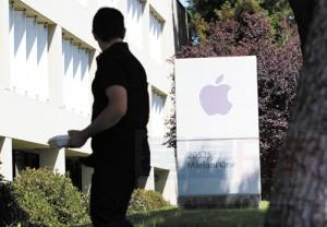 FILE - In this Aug. 25, 2011 file photo, an Apple employee walks between Apple buildings at Apple headquarters in Cupertino, Calif. Facebook and Apple, long known for cushy perks such as free meals, laundry service and massages, are among some of Silicon Valley's biggest companies now eyeing reproductive expenses as the next batch of benefits to offer to their employees. (AP Photo/Paul Sakuma, File)