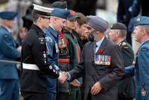 Defence Minister Harjit Singh Sajjan shakes hands with a cadet during the Remembrance Day ceremony in Ottawa on Wednesday, Nov. 11, 2015. THE CANADIAN PRESS/Adrian Wyld