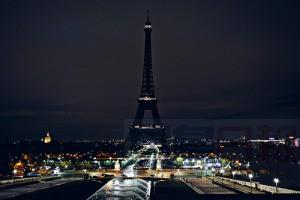 TOPSHOTS A picture taken on November 14, 2015 shows the Eiffel Tower with its lights turned off following the deadly attacks in Paris. Islamic State jihadists claimed a series of coordinated attacks by gunmen and suicide bombers in Paris that killed at least 129 people in scenes of carnage at a concert hall, restaurants and the national stadium.  AFP PHOTO / ALAIN JOCARD
