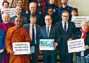 France's President Francois Hollande, center, holds a box containing an international petition to support the climate talks as he poses with religious figures for a group photo at the Elysee Palace in Paris, Thursday, Dec. 10, 2015. France's President Francois Hollande met religious figures lobbying against climate change on the side line of the COP21, United Nations Climate Change Conference in Le Bourget. (AP Photo/Michel Euler, Pool)