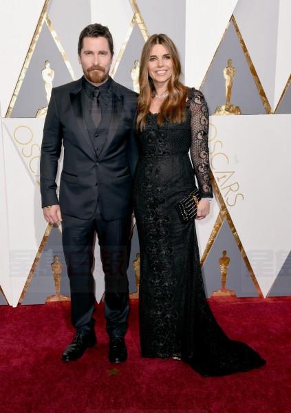 Christian Bale, left, and Sibi Blazic arrive at the Oscars on Sunday, Feb. 28, 2016, at the Dolby Theatre in Los Angeles. (Photo by Dan Steinberg/Invision/AP)