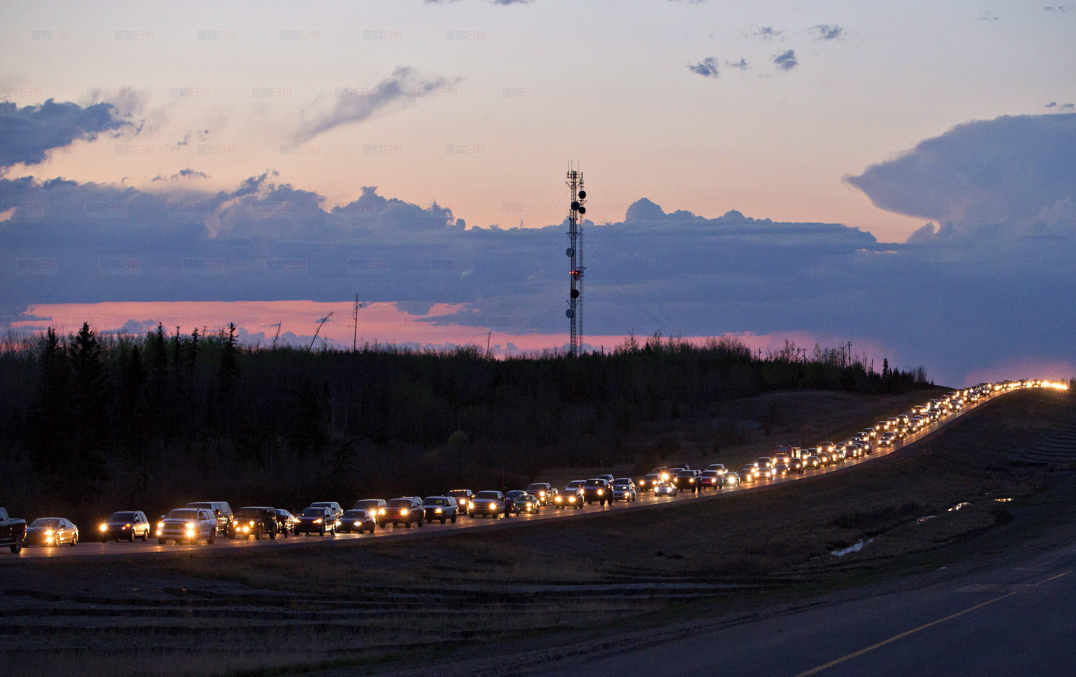 Traffic lines the highway as residents leave Fort McMurray, Alta., on Tuesday May 3, 2016. A wildfire has put all of Fort McMurray under a mandatory evacuation order which means that about 70,000 people who live in Fort McMurray are being told to flee the city. THE CANADIAN PRESS/Jason Franson