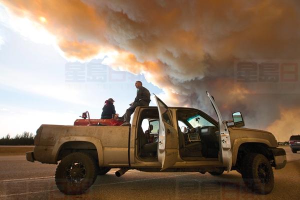 Animal rescue workers wait to get entry to Fort McMurray, Alta., on Friday, May 6, 2016. Officials said shifting winds were giving the embattled northern Alberta city a break, but they added the fire that forced 80,000 people from their homes remained out of control and was likely to burn for weeks. THE CANADIAN PRESS/Jason Franson