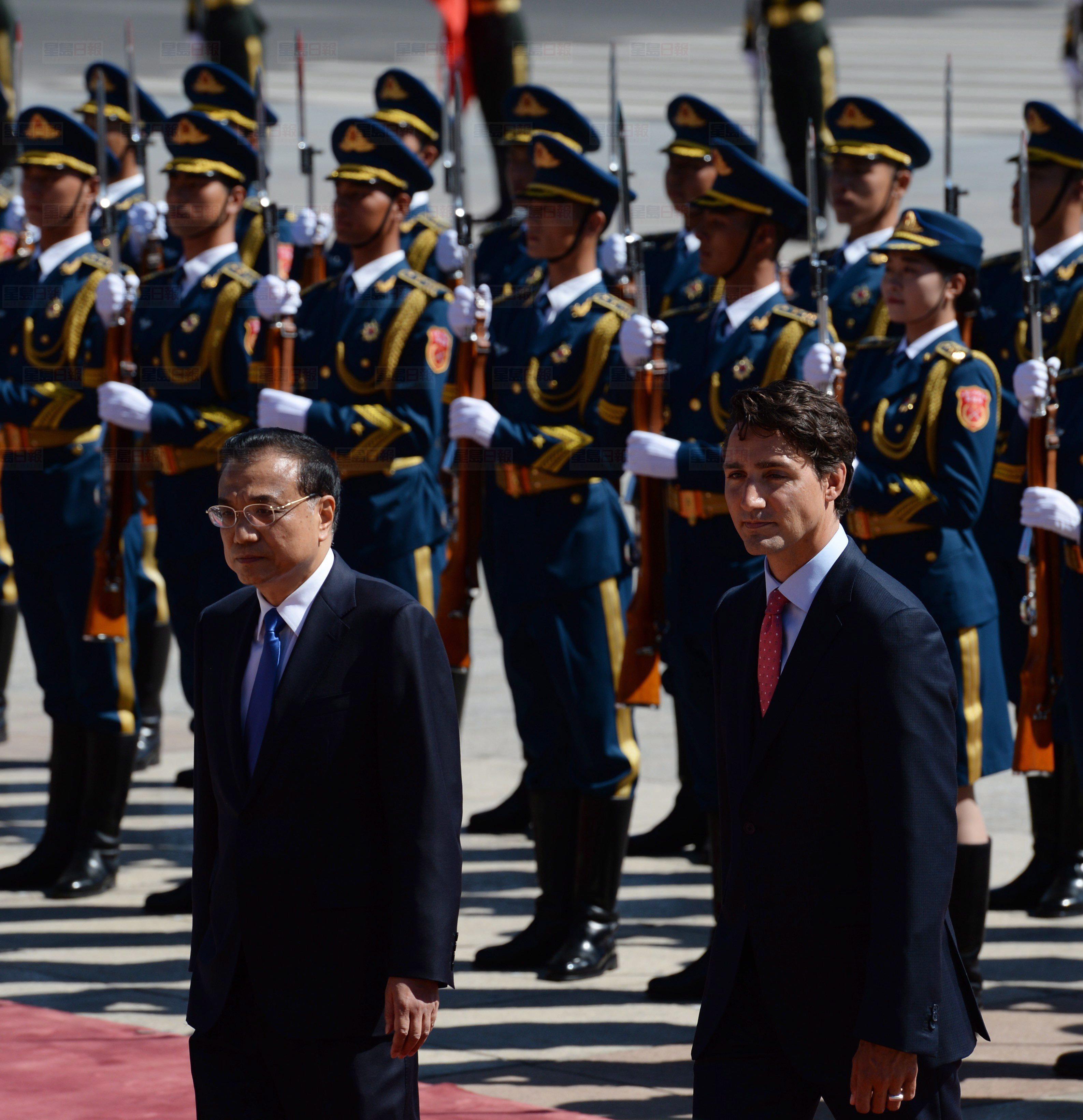 Canadian Prime Minister Justin Trudeau inspects an honour guard with the Premier of China Li Keqiang during an official welcoming ceremony at the Great Hall of the People in Beijing, Wednesday August 31, 2016. THE CANADIAN PRESS/Adrian Wyld
