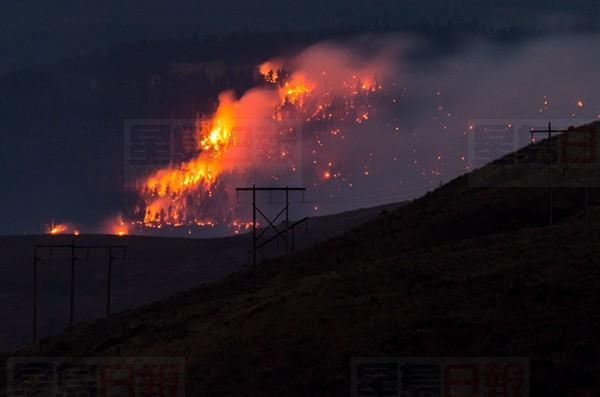 A wildfire burns on a mountain near Ashcroft, B.C., late Friday July 7, 2017. More than 3,000 residents have been evacuated from their homes in central British Columbia. A provincial state of emergency was declared after 56 new wildfires started Friday. THE CANADIAN PRESS/Darryl Dyck