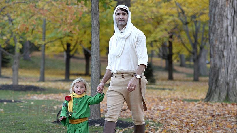 Prime Minister Justin Trudeau, dressed as the Pilot from The Little Prince, right, and his son Hadrien, dressed as the Little Prince, arrive at Rideau Hall to go trick-or-treating, on Halloween, Monday, Oct. 31, 2016 in Ottawa. (Justin Tang/CP)