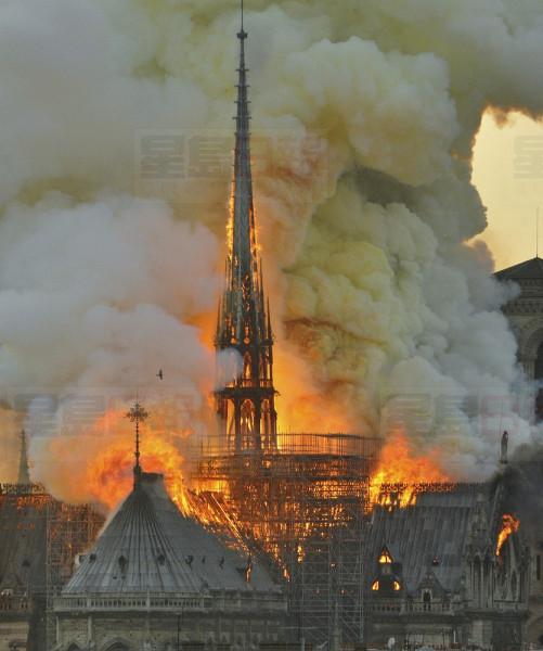 In this image made available on Tuesday April 16, 2019 flames and smoke rise from the blaze at Notre Dame cathedral in Paris, Monday, April 15, 2019. An inferno that raged through Notre Dame Cathedral for more than 12 hours destroyed its spire and its roof but spared its twin medieval bell towers, and a frantic rescue effort saved the monument's "most precious treasures," including the Crown of Thorns purportedly worn by Jesus, officials said Tuesday. (AP Photo/Thierry Mallet)