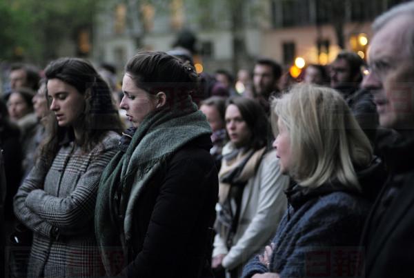 People gather at Saint Sulpice church in Paris before attending a candlelight vigil at Notre Dame Cathedral in Paris, Tuesday April 16, 2019. Firefighters declared success Tuesday in a more than 12-hour battle to extinguish an inferno engulfing Paris' iconic Notre Dame cathedral that claimed its spire and roof, but spared its bell towers and the purported Crown of Christ. (AP Photo/Kamil Zihnioglu)