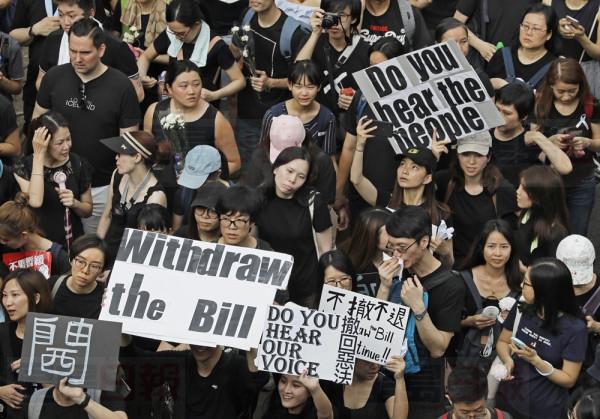 Protesters march through the streets against an extradition bill in Hong Kong on Sunday, June 16, 2019. Hong Kong residents Sunday continued their massive protest over an unpopular extradition bill that has highlighted the territory's apprehension about relations with mainland China, a week after the crisis brought as many as 1 million into the streets. (AP Photo/Vincent Yu)