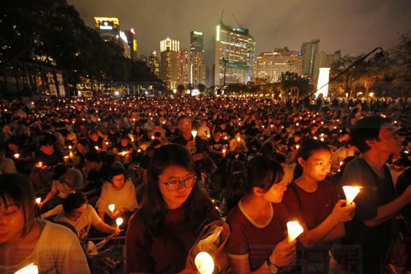 Thousands of people attend a candlelight vigil for victims of the Chinese government's brutal military crackdown three decades ago on protesters in Beijing's Tiananmen Square at Victoria Park in Hong Kong, Tuesday, June 4, 2019. Hong Kong is the only region under Beijing's jurisdiction that holds significant public commemorations of the 1989 crackdown and memorials for its victims. Hong Kong has a degree of freedom not seen on the mainland as a legacy of British rule that ended in 1997. (AP Photo/Kin Cheung)