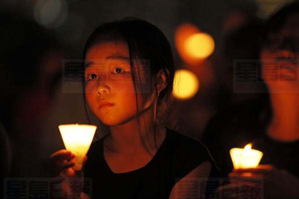 Thousands of people attend a candlelight vigil for victims of the Chinese government's brutal military crackdown three decades ago on protesters in Beijing's Tiananmen Square at Victoria Park in Hong Kong, Tuesday, June 4, 2019. Hong Kong is the only region under Beijing's jurisdiction that holds significant public commemorations of the 1989 crackdown and memorials for its victims. Hong Kong has a degree of freedom not seen on the mainland as a legacy of British rule that ended in 1997. (AP Photo/Kin Cheung)