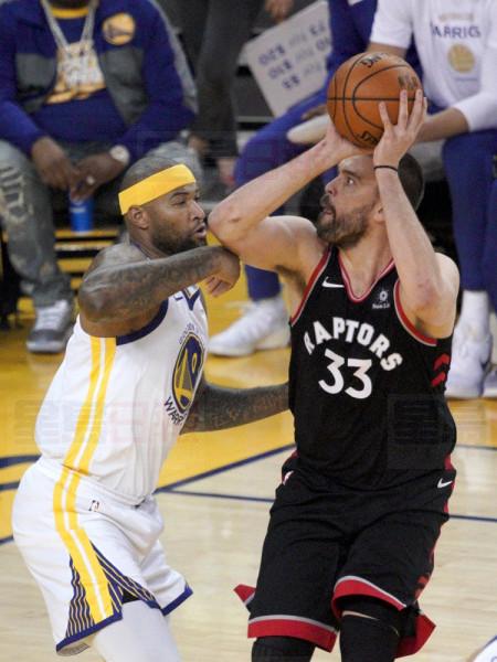 Toronto Raptors center Marc Gasol (33) shoots against Golden State Warriors center DeMarcus Cousins during the first half of during Game 3 of basketball's NBA Finals in Oakland, Calif., Wednesday, June 5, 2019. (AP Photo/Tony Avelar)