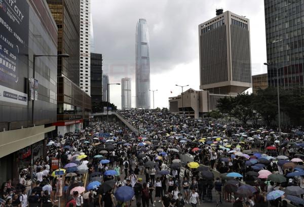 THousands of protesters gather outside the Legislative Council in Hong Kong, Wednesday, June 12, 2019. Hundreds of protesters have blocked access to Hong Kong's legislature and government headquarters in a bid to block debate on a highly controversial extradition bill that would allow accused people to be sent to China for trial. (AP Photo/Vincent Yu)