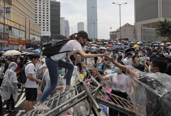 Protestors gather near the Legislative Council in Hong Kong, Wednesday, June 12, 2019. Thousands of protesters blocked entry to Hong Kong's government headquarters Wednesday, delaying a legislative session on a proposed extradition bill that has heightened fears over greater Chinese control and erosion of civil liberties in the semiautonomous territory. (AP Photo/Kin Cheung)