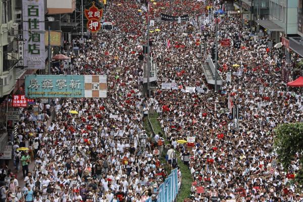Protesters march along a downtown street to against the proposed amendments to an extradition law in Hong Kong Sunday, June 9, 2019. The amendments have been widely criticized as eroding the semi-autonomous Chinese territory's judicial independence by making it easier to send criminal suspects to mainland China, where they could face vague national security charges and unfair trials. (AP Photo/Vincent Yu)