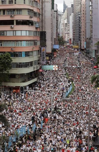 Protesters march along a downtown street against the proposed amendments to an extradition law in Hong Kong Sunday, June 9, 2019. The amendments have been widely criticized as eroding the semi-autonomous Chinese territory's judicial independence by making it easier to send criminal suspects to mainland China, where they could face vague national security charges and unfair trials. (AP Photo/Vincent Yu)