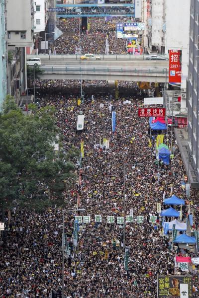 Ten of thousands of protesters flood the streets as they take part in a rally Monday, July 1, 2019, in Hong Kong. Combative protesters tried to break into the Hong Kong legislature Monday as a crowd of thousands prepared to start a march in that direction on the 22nd anniversary of the former British colony's return to China. (AP Photo/Kin Cheung)