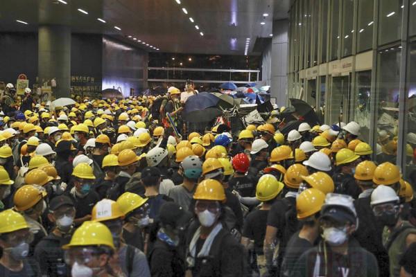 Protesters gather outside the Legislative Council as they stage a rally in Hong Kong, Monday, July 1, 2019. Combative protesters are staging a protest outside the Hong Kong legislature as a crowd of thousands prepares to start a march in that direction.(AP Photo/Vincent Yu)