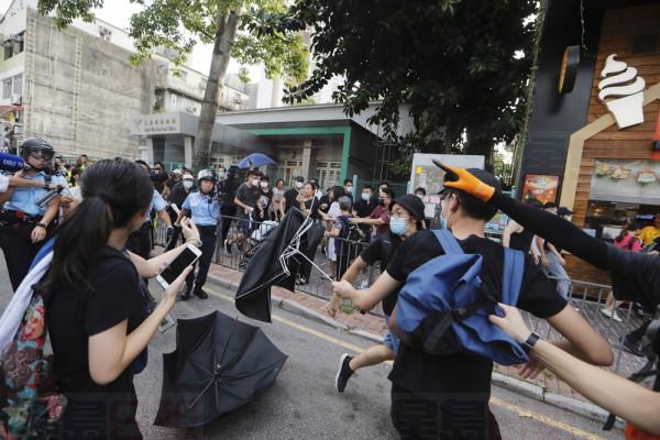 Police and protesters scuffle in Hong Kong Saturday, July 13, 2019. Several thousand people marched in Hong Kong on Saturday against traders from mainland China in what is fast becoming a summer of unrest in the semi-autonomous Chinese territory. (AP Photo/Kin Cheung)