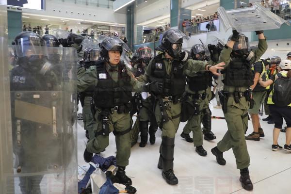Riot policemen move in to clear the protesters inside a mall in Sha Tin District in Hong Kong, Sunday, July 14, 2019. Police in Hong Kong have fought with protesters as they broke up a demonstration by thousands of people demanding the resignation of the Chinese territory's chief executive and an investigation into complains of police violence. (AP Photo/Kin Cheung)
