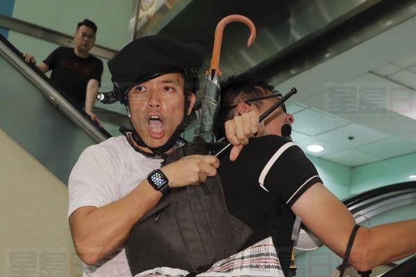 A policeman arrests a protester inside a shopping mall in Sha Tin District in Hong Kong, Sunday, July 14, 2019. Police in Hong Kong have fought with protesters as they broke up a demonstration by thousands of people demanding the resignation of the Chinese territory's chief executive and an investigation into complains of police violence. (AP Photo/Kin Cheung)