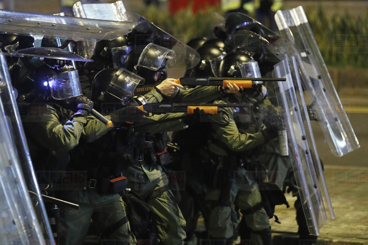Riot police officer point weapons during confrontation with protesters in Hong Kong on Sunday, July 21, 2019. Protesters in Hong Kong pressed on Sunday past the designated end point for a march in which tens of thousands repeated demands for direct elections in the Chinese territory and an independent investigation into police tactics used in previous demonstrations. (AP Photo/Vincent Yu)