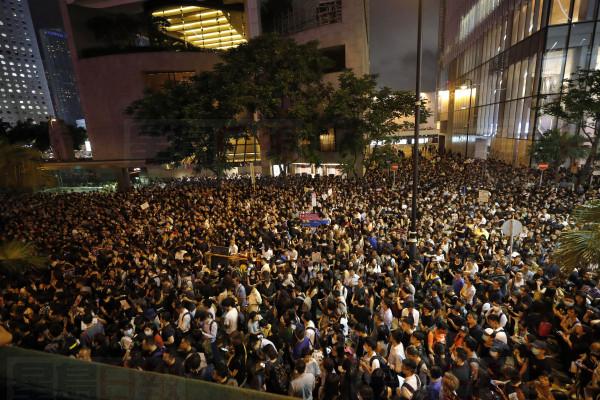 Protesters gather at a demonstration by civil servants in Hong Kong Friday, Aug. 2, 2019. Protesters plan to return to the streets again this weekend, angered by the government's refusal to answer their demands, violent tactics used by police - possibly in coordination with organized crime figures. (AP Photo/Vincent Thian)
