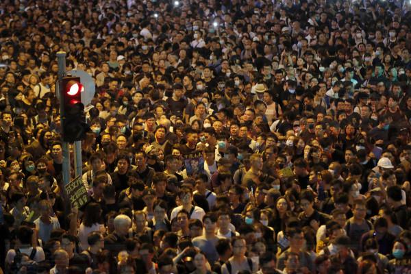 Protesters gather at a demonstration by civil servants in Hong Kong Friday, Aug. 2, 2019. Protesters plan to return to the streets again this weekend, angered by the government's refusal to answer their demands, violent tactics used by police - possibly in coordination with organized crime figures. (AP Photo/Vincent Thian)