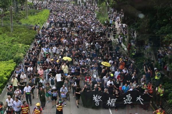 Protesters march with a banner that reads: "Police authority is too big" in Hong Kong Saturday, Aug. 3, 2019. Hong Kong protesters ignored police warnings and streamed past the designated endpoint for a rally Saturday in the latest of a series of demonstrations targeting the government of the semi-autonomous Chinese territory. (Steve Leung/HK01 via AP)