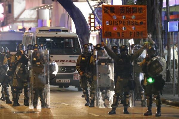 Police prepare to disperse protesters near the Tsim Sha Tsui police station in Hong Kong on Saturday, Aug. 10, 2019. Hong Kong is in its ninth week of demonstrations that began in response to a proposed extradition law but have expanded to include other grievances and demands for more democratic freedoms. (AP Photo/Vincent Thian)