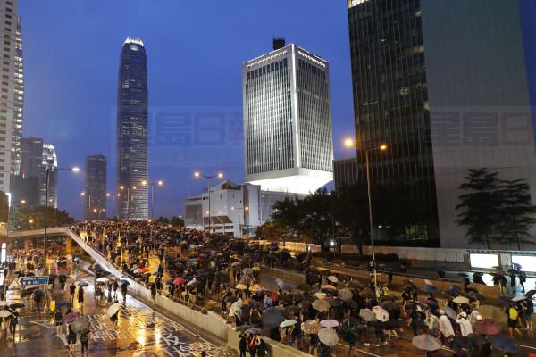 Protesters march in the rain in Hong Kong Sunday, Aug. 18, 2019. Heavy rain fell on tens of thousands of umbrella-toting protesters Sunday as they marched from a packed park and filled a major road in Hong Kong, where mass pro-democracy demonstrations have become a regular weekend activity this summer. (AP Photo/Vincent Thian)