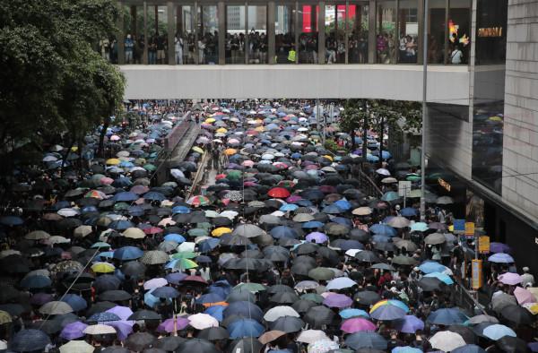 Pro-democracy protestors march in central Hong Kong, Saturday, Aug. 31, 2019. Large crowds of protesters are gathering and marching in central Hong Kong as police ready for possible confrontations near the Chinese government's main office or elsewhere in the city. The black-shirted protesters have taken over parts of major roads and intersections Saturday as they rally and march. (AP Photo/Jae C. Hong)
