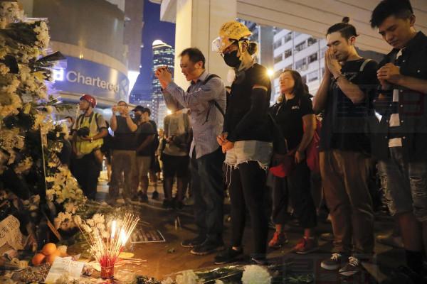 People pay their respects for protesters who were injured on Aug 31 outside Prince Edward station in Hong Kong on Friday, Sept. 6, 2019. The ratings agency Fitch on Friday cut Hong Kong's credit rating and warned that conflict with anti-government protesters was hurting the image of its business climate. (AP Photo/Kin Cheung)