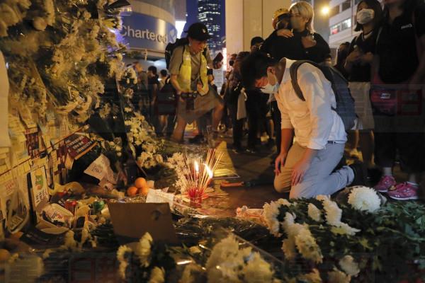 People pay their respects for protesters who were injured on Aug 31 outside Prince Edward station in Hong Kong on Friday, Sept. 6, 2019. The ratings agency Fitch on Friday cut Hong Kong's credit rating and warned that conflict with anti-government protesters was hurting the image of its business climate. (AP Photo/Kin Cheung)
