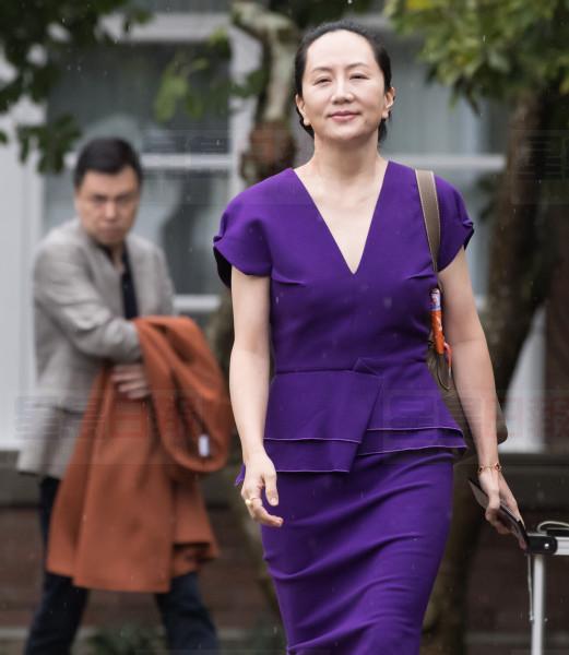 Huawei chief financial officer Meng Wanzhou, who is out on bail and remains under partial house arrest after she was detained last year at the behest of American authorities, and her husband Liu Xiaozong, back left, leave their home to attend a court hearing in Vancouver, on Monday September 23, 2019. THE CANADIAN PRESS/Darryl Dyck