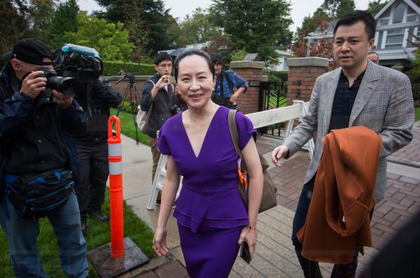 Huawei chief financial officer Meng Wanzhou, centre, who is out on bail and remains under partial house arrest after she was detained last year at the behest of American authorities, and her husband Liu Xiaozong, right, leave their home to attend a court hearing in Vancouver, on Monday, September 23, 2019. THE CANADIAN PRESS/Darryl Dyck