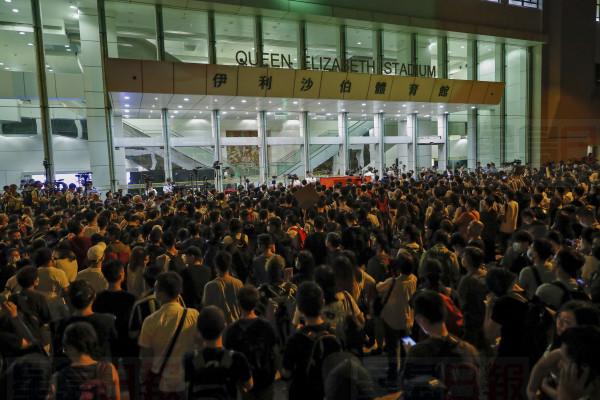 Protesters gather outside the Queen Elizabeth Stadium in Hong Kong, Thursday, Sept. 26, 2019. Scores of protesters chanted slogans outside the venue in downtown Hong Kong as embattled city leader Carrie Lam began a town hall session Thursday aimed at cooling down months of demonstrations for greater democracy in the semi-autonomous Chinese territory. (AP Photo/Vincent Thian)