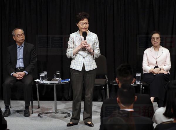 Hong Kong Chief Executive Carrie Lam speaks during a community dialogue with selected participants at the Queen Elizabeth Stadium in Hong Kong, Thursday, Sept. 26, 2019. Scores of protesters chanted slogans outside a stadium in downtown Hong Kong as embattled city leader Carrie Lam began a town hall session Thursday aimed at cooling down months of demonstrations for greater democracy in the semi-autonomous Chinese territory. (AP Photo/Kin Cheung)