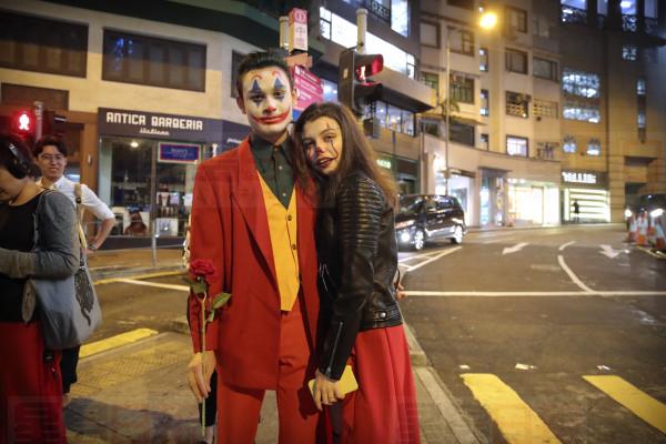 A couple wearing Halloween costumes stand on a street in Hong Kong, Thursday, Oct. 31, 2019. Hong Kong protesters are calling for people to mark Halloween by wearing masks depicting government officials or scary characters. Authorities are bracing for Thursday night's rally, which will put to the test a government ban on face coverings at public gatherings introduced this month to help quell the increasingly violent protests now in their fifth month. (AP Photo/Kin Cheung)