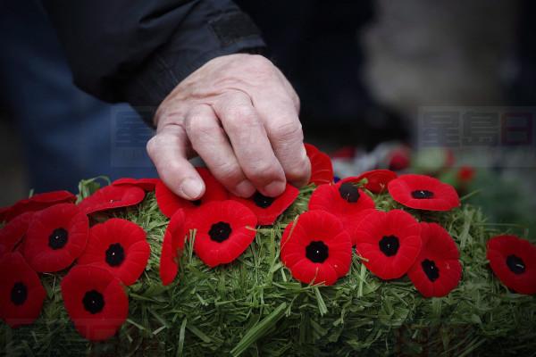 Poppies are placed on a wreath at a cenotaph during a Remembrance Day service in Winnipeg, Saturday, Nov. 11, 2017. Canadians will gather at cenotaphs and monuments across the country this morning to remember and honour those who took up arms ??? and in some cases paid the ultimate price ??? to defend this country and its way of life.THE CANADIAN PRESS/John Woods