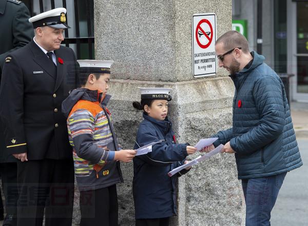 Young sea cadets hand out programs at Remembrance Day ceremonies at the Grand Parade in Halifax on Monday, Nov. 11, 2019. THE CANADIAN PRESS/Andrew Vaughan
