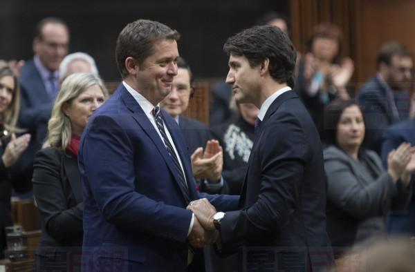 Prime Minister Justin Trudeau shakes hands with Leader of the Opposition Andrew Scheer after he announced he will step down as leader of the Conservatives, Thursday December 12, 2019 in the House of Commons in Ottawa. THE CANADIAN PRESS/Adrian Wyld
