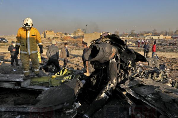 Rescue workers search the scene where a Ukrainian plane crashed in Shahedshahr, southwest of the capital Tehran, Iran, Wednesday, Jan. 8, 2020. A Ukrainian airplane with more than 170 people crashed on Wednesday shortly after takeoff from Tehran's main airport, killing all onboard. (AP Photo/Ebrahim Noroozi)