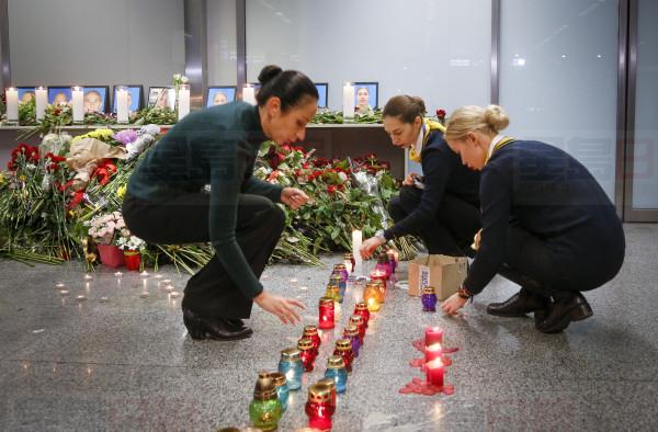 Colleagues of the flight crew members of the Ukrainian 737-800 plane that crashed on the outskirts of Tehran, light candles at a memorial inside Borispil international airport outside Kyiv, Ukraine, Wednesday, Jan. 8, 2020. A Ukrainian airplane carrying 176 people crashed on Wednesday shortly after takeoff from Tehran's main airport, killing all onboard, Iranian state TV and officials in Ukraine said. (AP Photo/Efrem Lukatsky)