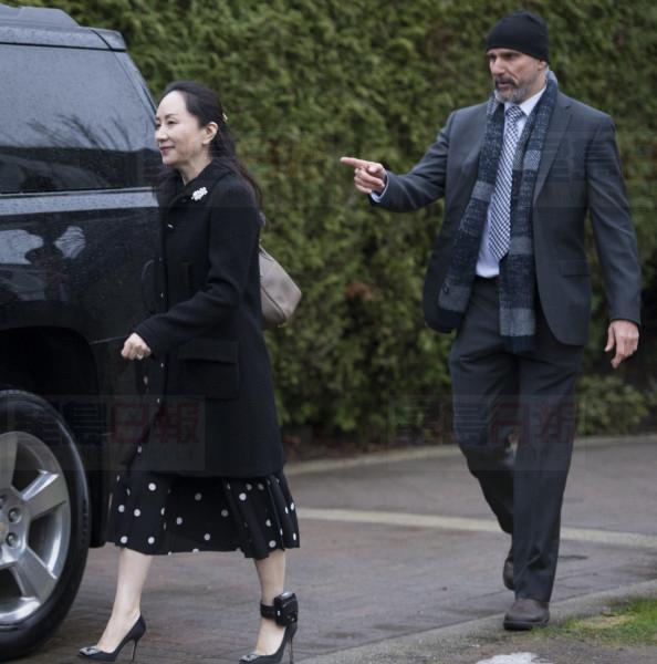 A security member points the way as Meng Wanzhou, chief financial officer of Huawei, leaves her home in Vancouver, Monday, January, 20, 2020. A court hearing begins today in Vancouver over the American request to extradite an executive of the Chinese telecom giant Huawei on fraud charges. THE CANADIAN PRESS/Jonathan Hayward
