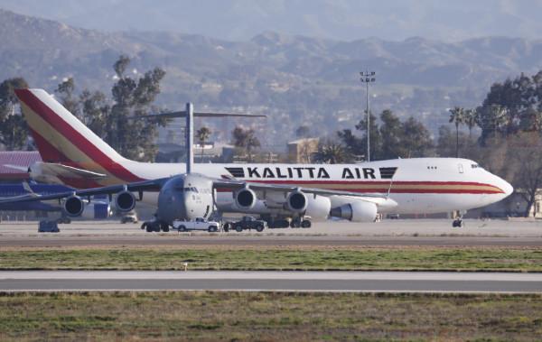 An airplane carrying U.S. citizens being evacuated from Wuhan, China, lands at March Air Reserve Base in Riverside, Calif. Jan. 29, 2020.   The passengers will undergo additional screenings in California and be placed in temporary housing. Officials have not said how long they will stay there.  (AP Photo/Ringo H.W. Chiu)