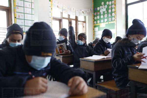 Students wear masks as a precautionary measure at Matribhumi school in Bhaktapur, Nepal, Wednesday, Jan. 29, 2020. There has been one confirmed case of a new coronavirus infection in the Himalayan country. (AP Photo/Niranjan Shrestha)